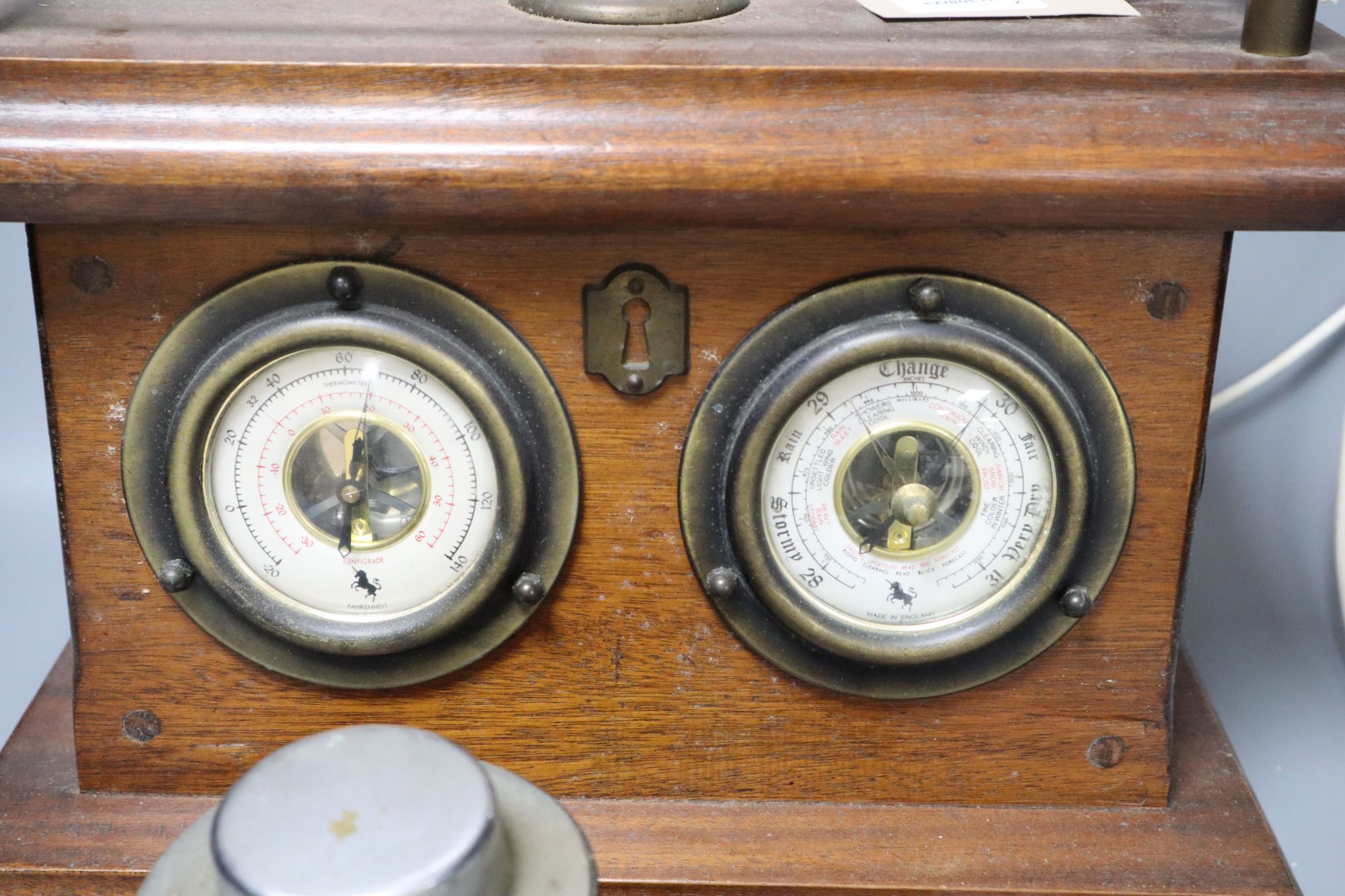 An Art Deco chromium desk calendar/barometer and a mahogany table lamp with thermometer and barometer dials